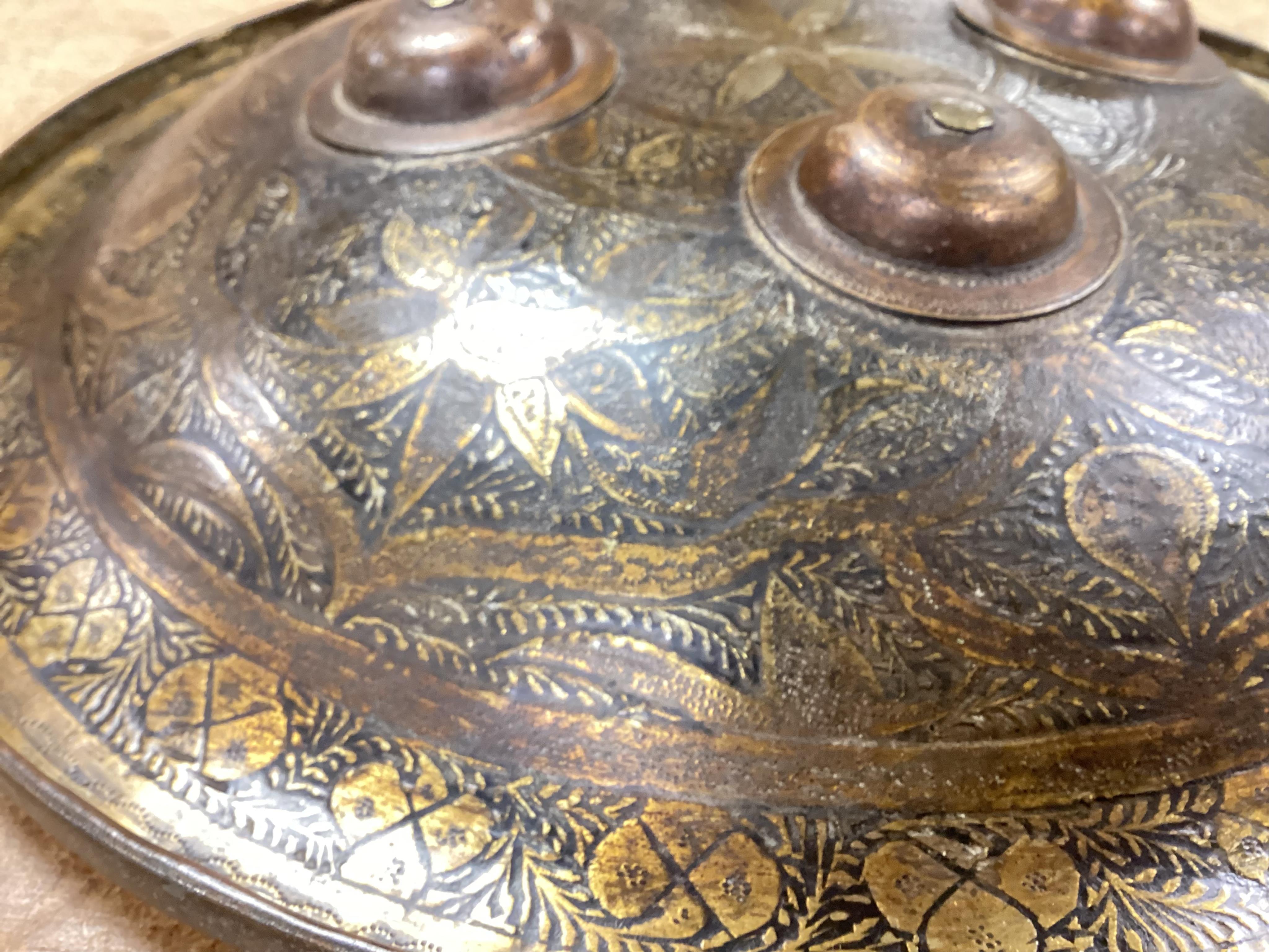 Two Persian style shields, one papier mache the other metal, largest 34cm diameter. Condition - good